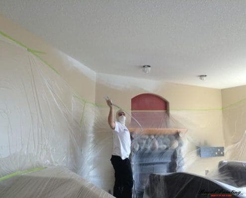 Armando spray painting the walls