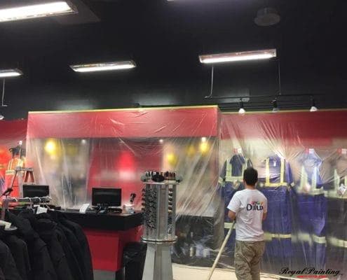 Armando painting the interior of a commercial building